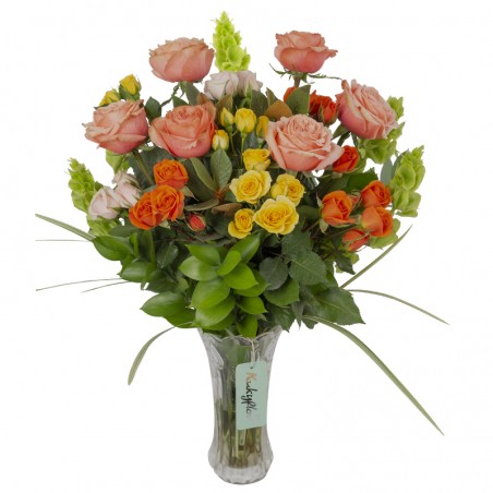 Arrangement of garden roses with mini roses in a vase.