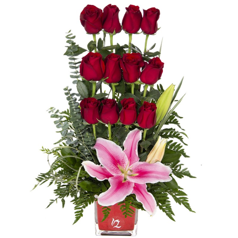 Arrangement of 12 red roses and scented lilies on a glass base