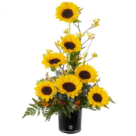 Arrangement of 7 sunflowers on a glass base