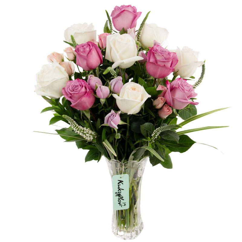 Arrangement of garden roses with mini roses in a vase.