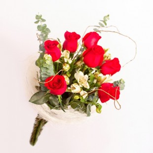 Bouquet de rosas rojas y flores blancas con follaje verde.