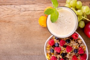 Healthy breakfast on wooden table, focused on drink.