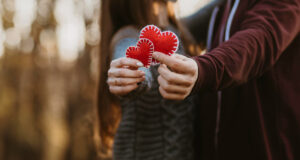 Pareja de novios con corazones de tela.