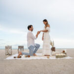 Loving couple getting engaged on a romantic picnic at the beach
