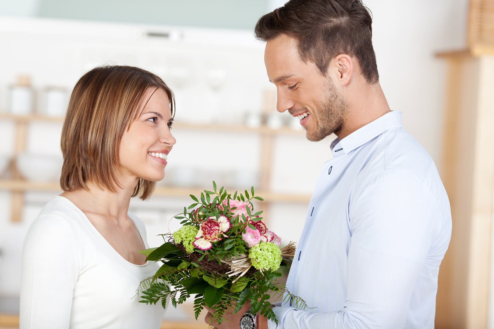 San Valentín, pareja regalando flores.